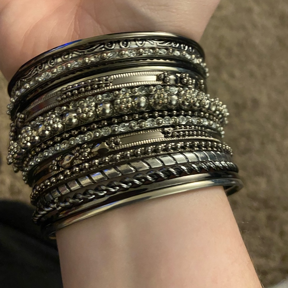 Set of 16 silver detailed bangles. Worn twice, the brand SO from kohls